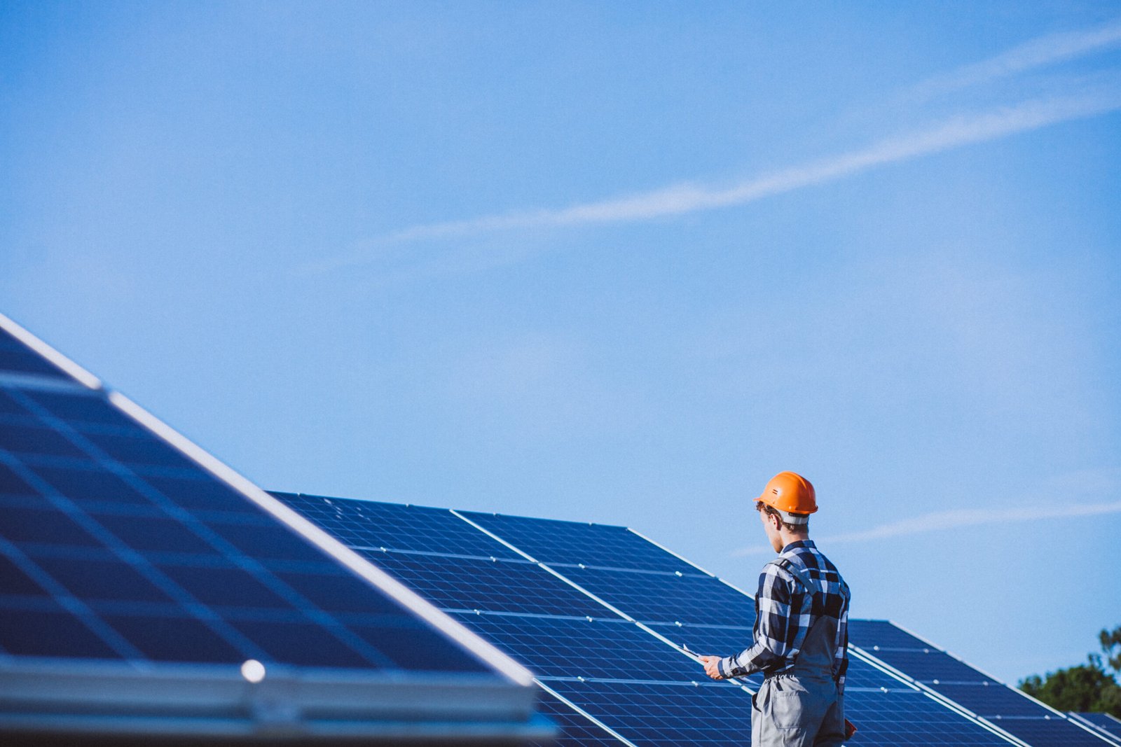 man worker firld by solar panels scaled